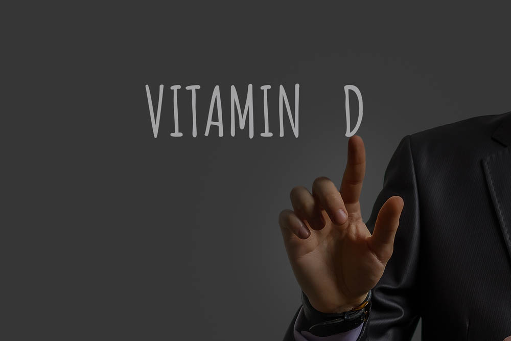 businessman's hand shows vitamin d