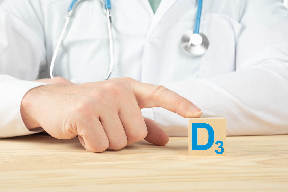 essential vitamins and minerals for humans. doctor recommends taking vitamin D. doctor talks about the benefits of vitamin D3. D3 Vitamin - Health Concept. D alphabet on wood cube.
