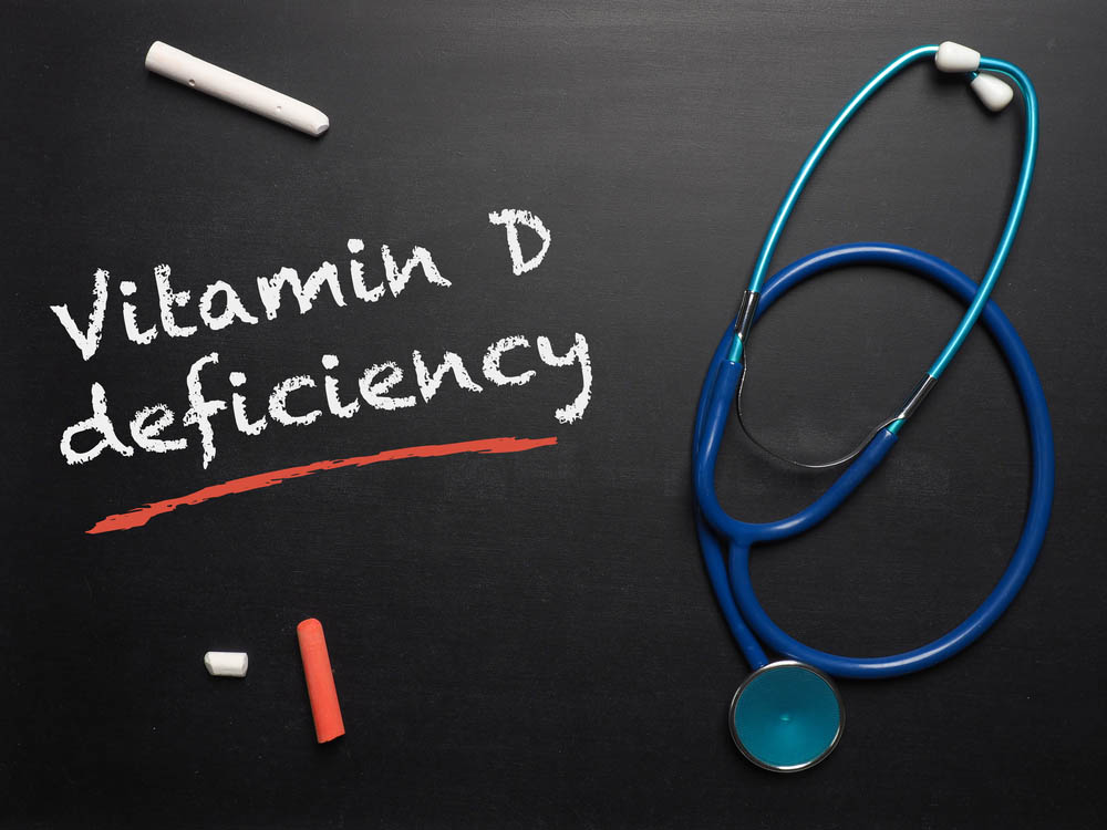Blackboard with the words Vitamin D deficiency and a stethoscope, medical or health care concept