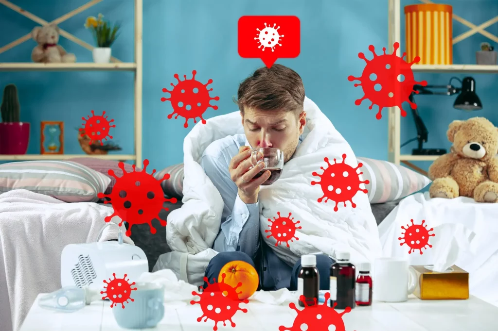 Man with cold symptoms surrounded by virus graphics