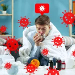 Man with cold symptoms surrounded by virus graphics